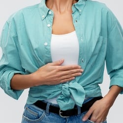someone pointing to their stomach