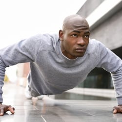 Supports the Immune System – Young man in plank stance outdoors