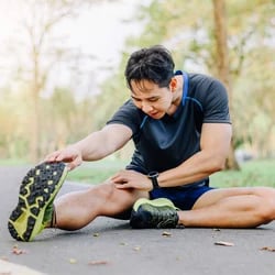 Someone stretching in a park