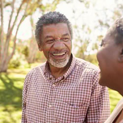 Elderly couple laughing in the park