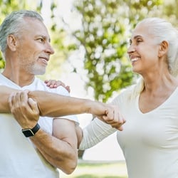 Avoid D Deficiency – Elderly couple stretching together in the park