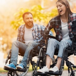 Enables a Happy Mood – A couple in wheelchairs happily playing outdoors